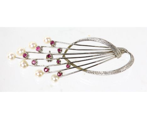 Pearl and ruby brooch, seven pearls and ten rubies set in a spray design, in stamped 18ct white gold, length 55mmCondition Re