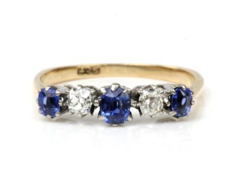 Sapphire and diamond ring, three cushion cut sapphires, with two cushion cut diamonds set in between, in stamped 9ct yellow g