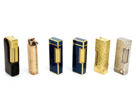 Six Dunhill lighters including two enamel blue marl rollagas lighters with boxes, a silver bark rollagas lighter, two gold pl