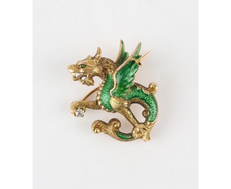 A dragon brooch, holding an old cut diamond, a green gem set eye, with green guilloche enamel body and wings, in stamped 14ct