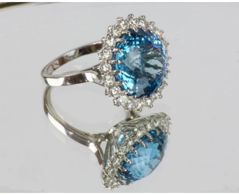 Blue topaz and diamond dress ring, round fancy cut blue topaz, dimensions 14.44 x14.36 x 10.08mm, with a surround of round br