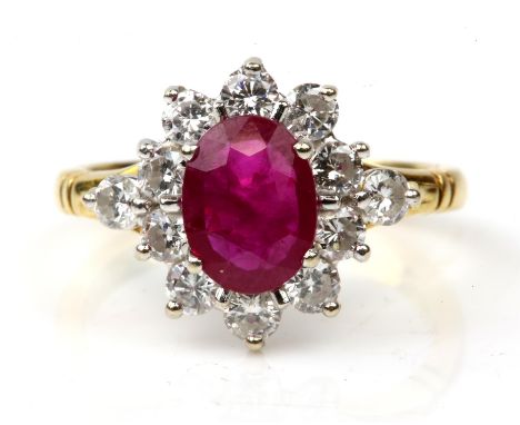 Ruby and diamond cluster ring, oval cut ruby, estimated weight 1.16 carats, with a surround or round brilliant cut diamonds, 