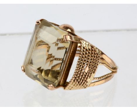 Citrine dress ring, an emerald cut citrine, 17.5 x 14.7 x 10.5mm, with rope design shoulders and shank, in tested 9ct gold, r