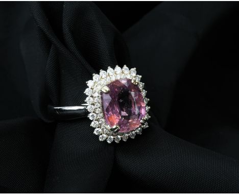 Pink sapphire and diamond cluster ring, a cushion cut natural pink sapphire weighing 3.99 carats, with a surround of two rows