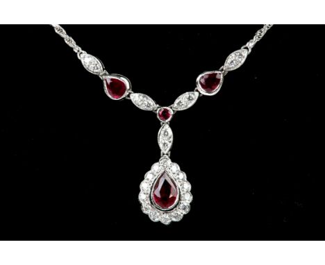 Ruby and diamond cluster drop pendant, the drop set with a central pear shaped ruby and a surround of round brilliant cut dia