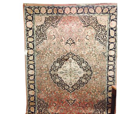 PURE SILK KASHMIR CARPET, 315cm x 215cm, central medallion on a field of scrolling vines and palmettes within corresponding s