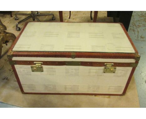 STEAMER STYLE TRUNK, tan leather bound with a rectangular glass cover and a rising top enclosing space for storage and carryi