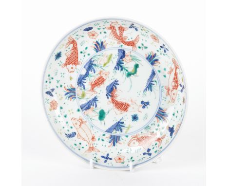 A CHINESE WUCAI `CARP' DISHProbably Kangxi Painted in the centre with two iron-red carp in a lotus pond, the well painted wit