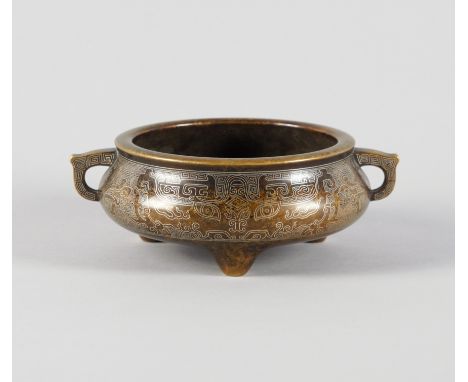A CHINESE BRONZE TWO-HANNDLED TRIPOD CENSERXuande seven character seal mark but later Of compressed form, inlaid with Shisou 