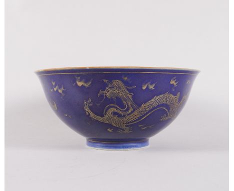 A CHINESE PORCELAIN BLUE-GROUND BOWLBlue Qianlong seal mark but later The exterior painted with two gilt dragons chasing pear