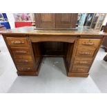 20th cent. Mahogany double pedestal desk, four drawers either side with carved handles, green