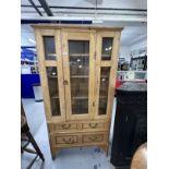 20th cent. Stripped pine display unit, two opening doors over two drawers. Approx. 67ins. x 35ins. x