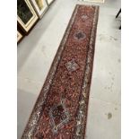 Rugs & Carpets: 20th cent. Runner, Asian style predominantly in red hues with striking blues and