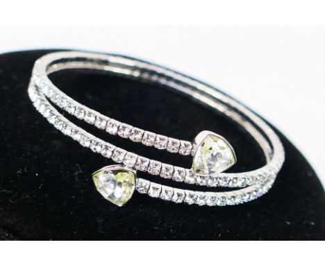 Swarovski - A boxed Swarovski #5086031 rhodium plated twisty triangle bangle. Appears in good condition. Comes with Swarovski
