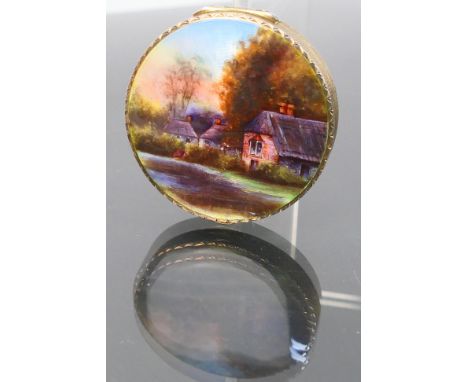 A silver vintage powder compact. Hand painted decoration to lid depicting a country side scene with gilt engine turned finish