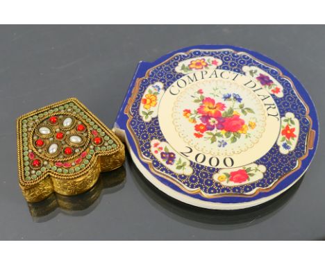 A vintage gilt metal, beautifully patterned powder compact. Powder compact has one hinge, built in interior mirror. No maker 