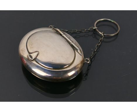 E.J Trevitt & Sons - An oval silver compact on a chain with assay marks for Chester 1917 and makers mark for E.J. Trevitt & S