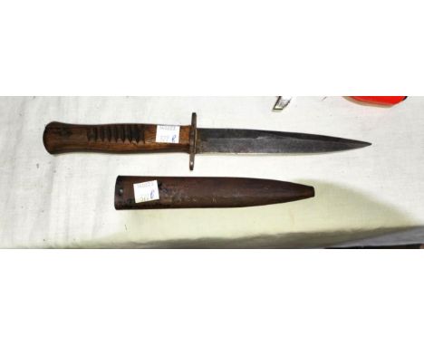 A German WWI period trench knife with wooden handle with carved grip marks, mark to blade unreadable, blade length 14.5cm wit