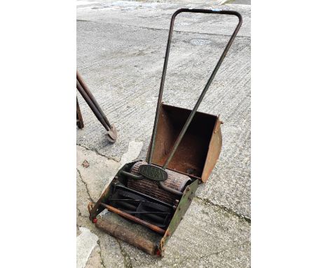 A vintage Greens push along rotary lawn mower 