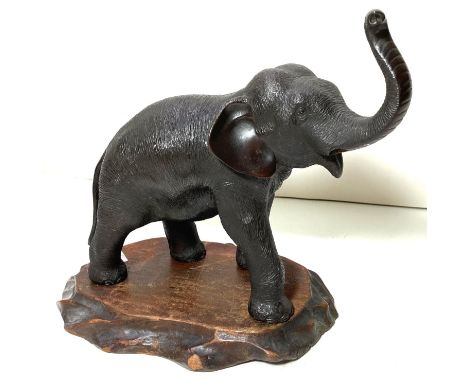 A Japanese Meiji period elephant with raised trunk, on wooden stand, highly detailed work on skin etc, on wooden base with ma