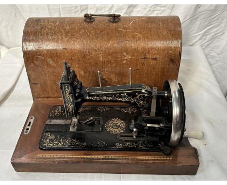 A vintage cased Jappaned metal sewing machine 