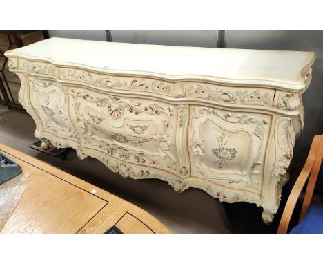 A large 18th century Italian style serpentine front commode with extensive floral and acanthus relief decoration, 3 frieze dr