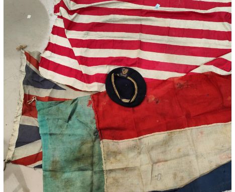 A selection of vintage flags and a woollen cap with a badge 