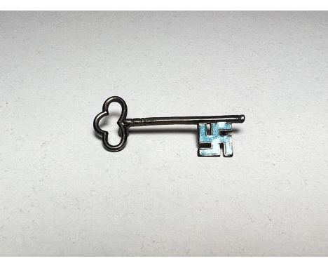 A white metal key shaped brooch with blue enamel Swastika shaped end (pin at back missing)&nbsp; 