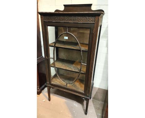 A 1920's period style mahogany china cabinet with beaded decoration and blind fret frieze, with single door and square tapere