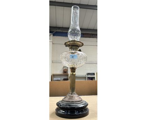 A 19th century Arts &amp; Crafts style oil lamp in copper and brass with bubbled glass reservoir and chimney 