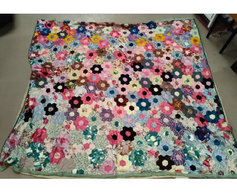 A large vintage patchwork quilt made up of hexagonal pieces in a floral shape, 215x200 cm&nbsp; 