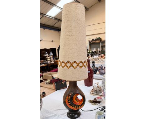 A 1960's West German Lava ware table lamp with brown ground with orange highlights with very tall original shade 