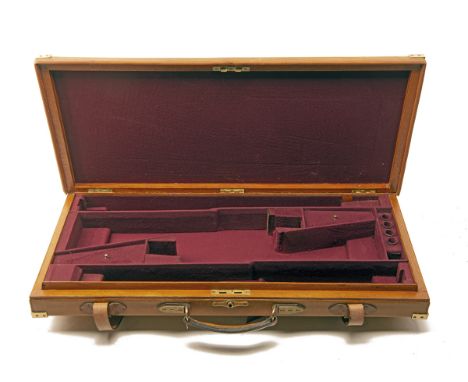 A BRASS-CORNERED OAK AND LEATHER UNIVERSAL DOUBLE GUNCASE, fitted for 30in. barrels, the interior maroon baize, brass push-bu