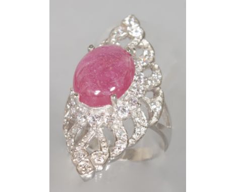 A SILVER AND CABOCHON RUBY BRILLIANT SET COCKTAIL RING.  