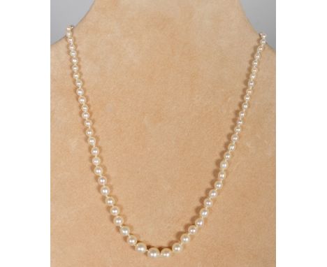 A CULTURED PEARL SINGLE ROW NECKLACE with diamond bow clasp.  