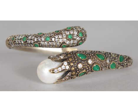 A SILVER AND GILT PEARL AND BRILLIANT SET SNAKE BANGLE.  