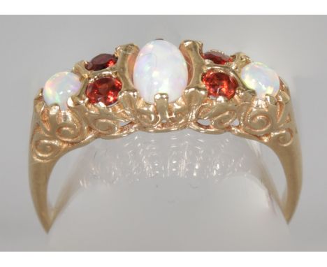 A 9CT YELLOW GOLD, OPAL AND GARNET RING.  