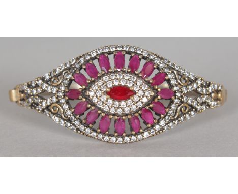 A GOOD RUBY AND BRILLIANT SET SILVER AND GILT BANGLE.  