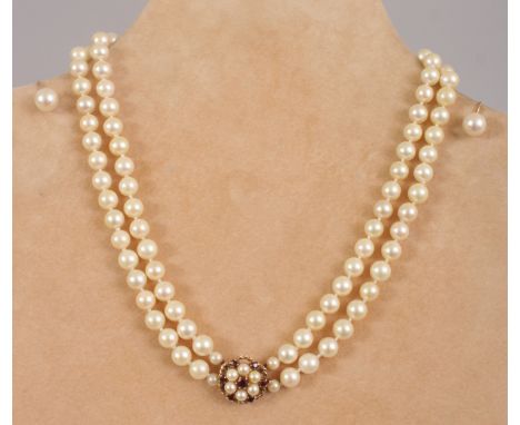 A DOUBLE ROW PEARL NECKLACE, gold and garnet clasp and a pair of PEARL STUD EARRINGS.  