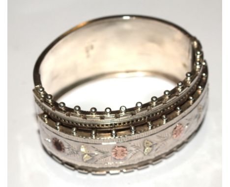 A gold mounted silver bangle