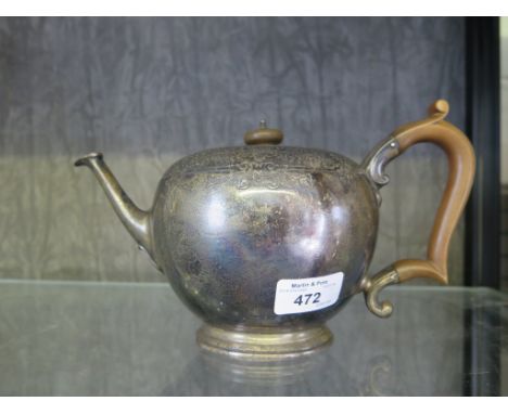 A bullet shape silver teapot having chased decoration, London 1934