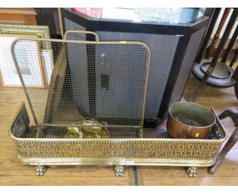 A Victorian brass fender, with pierced and beaded gallery on lion paw feet, a firescreen, copper pan and various other brassw
