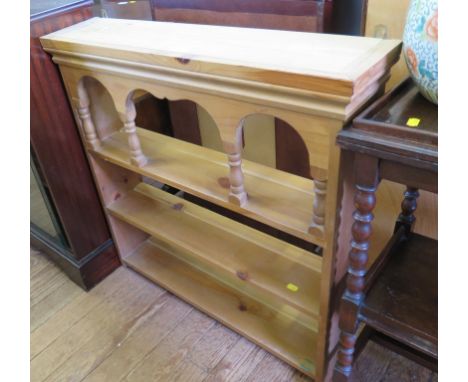 A pine wall rack, with arcaded top shelf on turned supports, 80cm wide