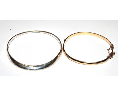 A 9 carat gold bangle with metal core and Marks & Spencers bangle