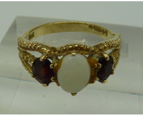 A 9ct gold, opal and garnet three stone ring, weight 2.6g, size L