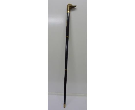 An ebonised walking cane with duck's head handle and internal flask