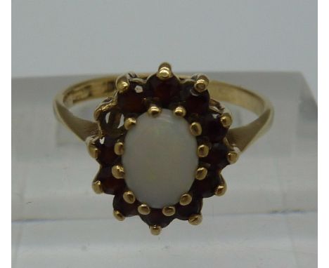 A 9ct gold, opal and red stone cluster ring, weight 2.2g, size M