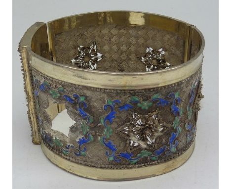 A white metal and enamel bangle, weight 46.7g, a/f