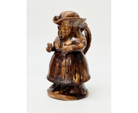 Martha Gunn Gin Lady. Mid 19th Century. A treacle glazed gin toby jug with original cover. 21.5cm