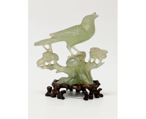 A Chinese carved jade bird and branch. Early 20th Century. 16x18cm